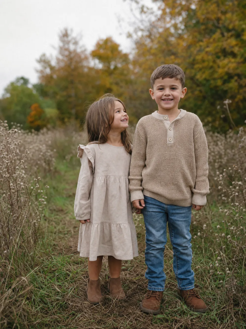 Kids in neutral-toned outfits during an outdoor fall mini-session, natural autumn light