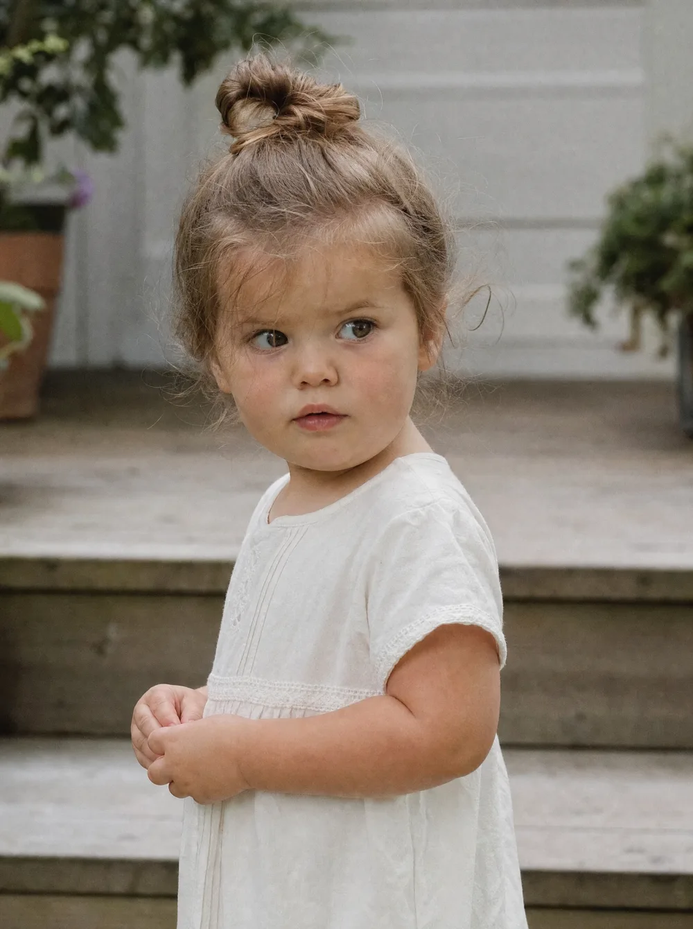 Candid toddler portrait outdoors in natural light, soft muted tones